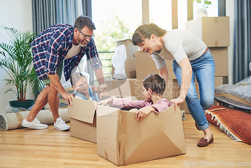 Image of Getting the family involved boosts family morale. Shot of a happy family having fun together on moving day.