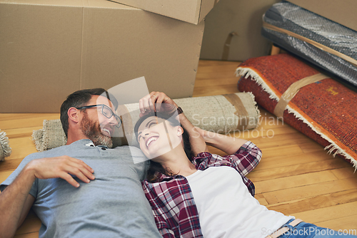 Image of We did it my love. Shot of a happy couple relaxing together in their home on moving day.