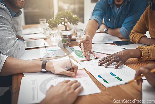 Image of Getting to the root in a timely manner. Shot of a group of businesspeople discussing statistics.