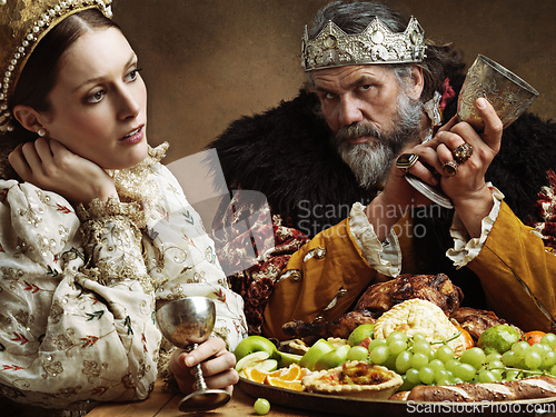 Image of Everyday banquets and more banquets. A bored queen sitting alongside her husband at a banquet.