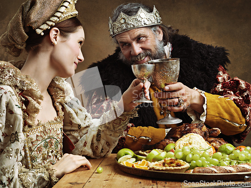 Image of Maybe a full goblet will cheer you up mlady. A mature king feasting alone in a banquet hall.