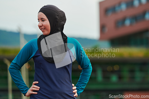 Image of A Muslim woman with a burqa, an Islamic sportswoman resting after a vigorous training session on the marathon course. A hijab woman is preparing for a marathon competition