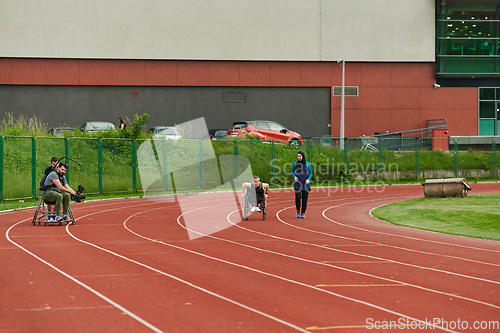 Image of A cameraman filming the participants of the Paralympic race on the marathon course