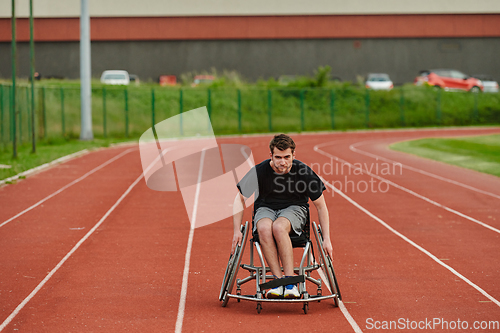 Image of A person with disability in a wheelchair training tirelessly on the track in preparation for the Paralympic Games