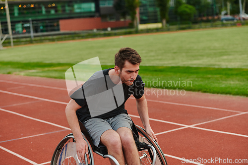 Image of A person with disability in a wheelchair training tirelessly on the track in preparation for the Paralympic Games