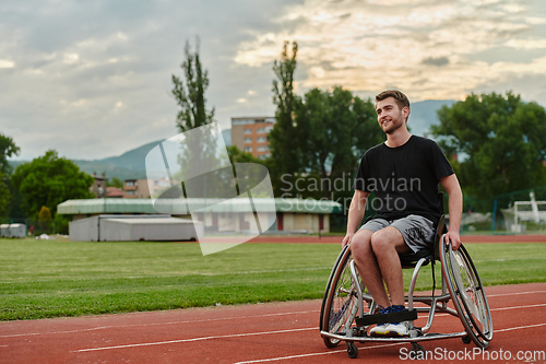 Image of A person with disability in a wheelchair training tirelessly on the track in preparation for the Paralympic Games