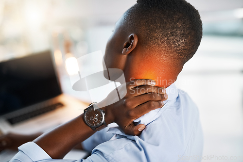 Image of I think its time I called it a day. Shot of a young unrecognizable businessman suffering from neck pain while trying to work in the office.