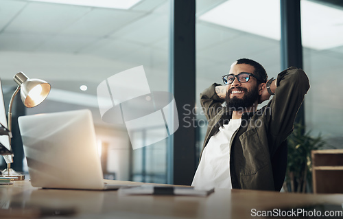 Image of I gave it my all, I got it all. Shot of a young businessman taking a break while working late at night in a modern office.