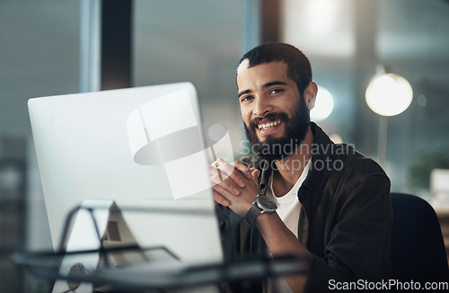 Image of Id work late every night for a job I love. Shot of a young businessman using a computer during a late night in a modern office.