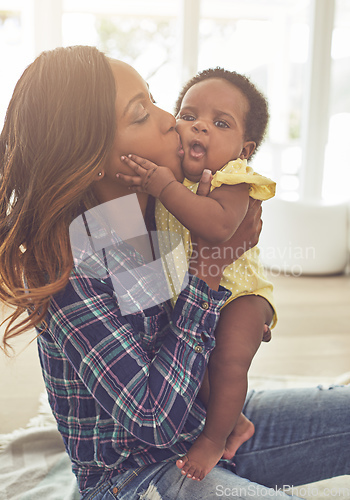 Image of Showering her with kisses. Cropped shot of a young mother and her little baby girl at home.