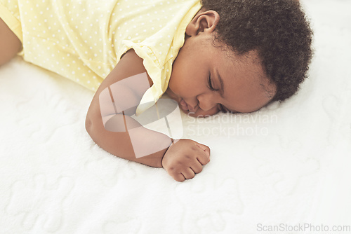 Image of Sleeping peacefully. Cropped shot of a baby girl asleep on a bed at home.