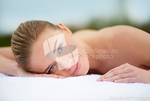 Image of Spending some quality time with myself. Cropped portrait of a young woman lying on a massage table.