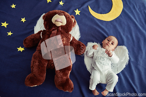 Image of Babies are angels sent from heaven. Concept shot of an adorable baby boy and a teddy bear wearing angel wings against an imaginary night time background.