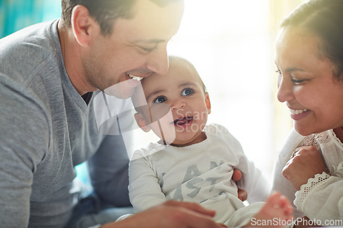 Image of Born into a home full of love. Shot of an adorable baby boy bonding with his father and father at home.