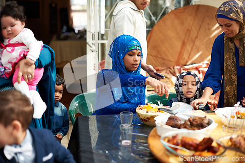 Image of Food brings everyone together. Shot of a muslim family eating together.