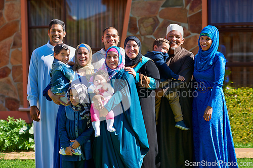 Image of Theyre one big happy family. Portrait of a happy muslim family standing together in front of their house.