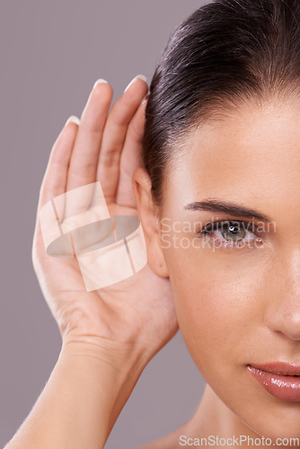 Image of Taking your beauty advice. Beauty shot of a young woman with a cupped hand behind her ear.