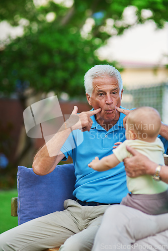 Image of Take a minute to just stop and play. Shot of a senior man playing with his grandson.