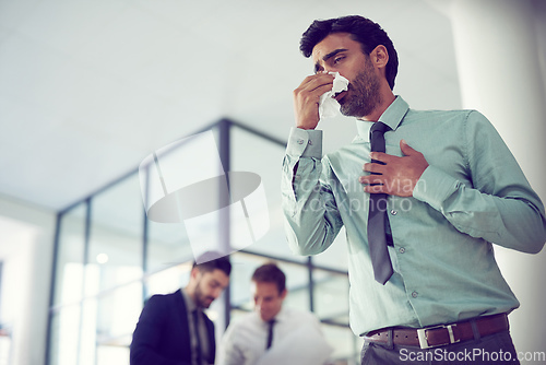 Image of Feeling groggy with flu. Cropped shot of a businessman suffering with allergies in an office.