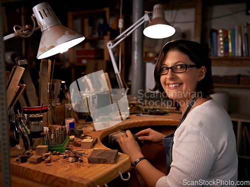 Image of Where I go to de-stress. Shot of a happy young woman sitting at a workbench.