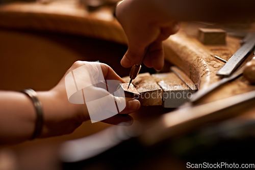 Image of Working with your hands is the purest art form. A person using a tool to work on a piece of wood.