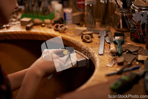 Image of The skills my father taught me. A person using a tool to work on a piece of wood.