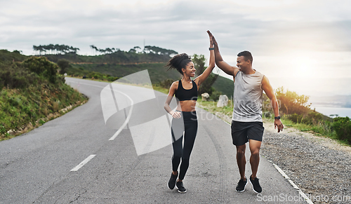 Image of What an amazing run that was. Shot of a sporty young couple high fiving each other while exercising outdoors.