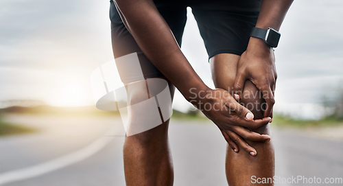 Image of This doesnt feel right. Closeup shot of a sporty man suffering with knee pain while exercising outdoors.