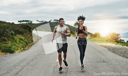 Image of Clocking some workout time in the fresh air. Shot of a sporty young couple exercising together outdoors.