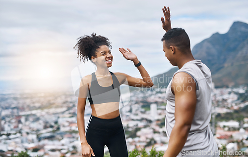 Image of Theyre pumped with so much energy. Shot of a sporty young couple high fiving each other while exercising outdoors.