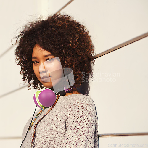 Image of Music is my culture. A young woman with headphones around her neck.