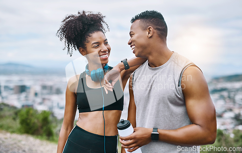 Image of Living well leads to true happiness. Shot of a sporty young couple taking a break while exercising outdoors.