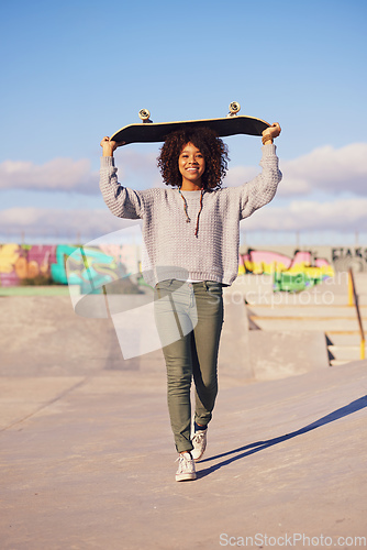 Image of Why walk when you can skate. Shot of a young woman out skateboarding in the city.