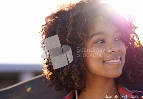 Image of Its a great day to skate. Shot of a young woman out skateboarding in the city.