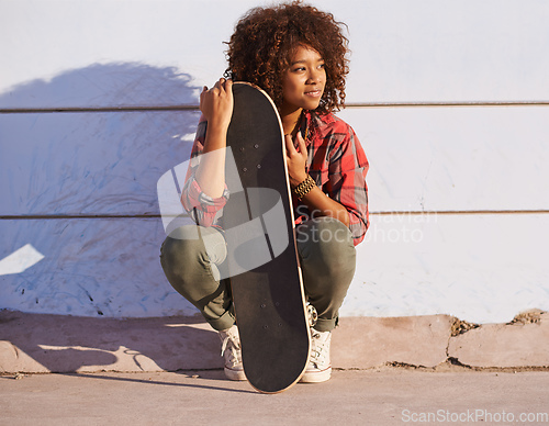 Image of Why walk when you can skate. Shot of a young woman out skateboarding in the city.