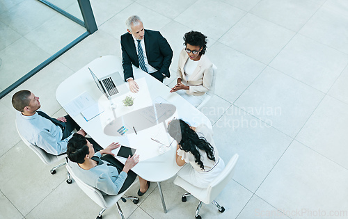 Image of Voicing her ideas. High angle shot of a group of businesspeople having a meeting.