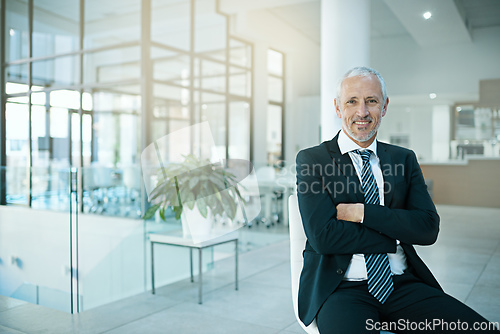 Image of Im committed to excellence. Portrait of a man sitting on a chair in an office.