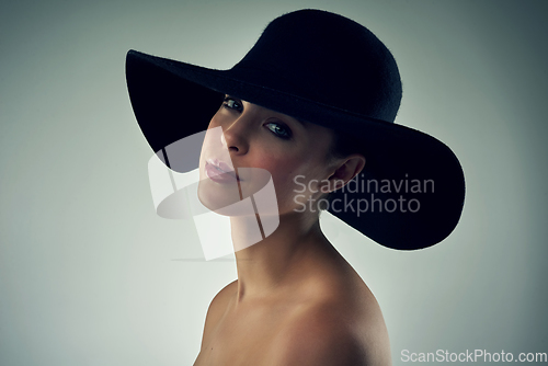 Image of Shes got that beauty to cause a stir. Studio portrait of a beautiful young woman wearing a hat against a grey background.