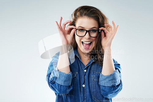 Image of Funky is my natural mood. Studio portrait of a young woman posing against a grey background.