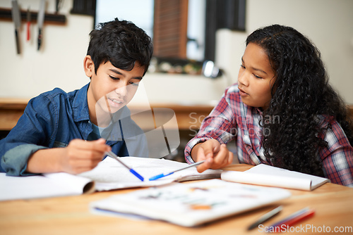 Image of Growing through a good education. Shot of two young students studying together in a classroom.