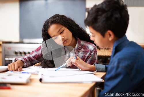 Image of Solving their homework together. Shot of two young students studying together in a classroom.