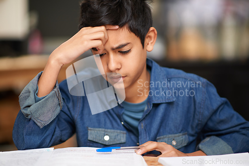 Image of Is there a solution to this algebra problem. Shot of a young teenage boy studying at a desk.