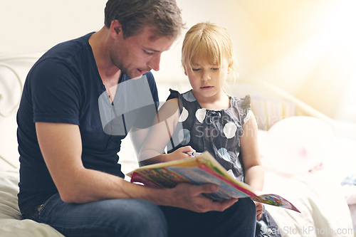 Image of Hes always there for her. Shot of a single dad helping his daughter with her homework.