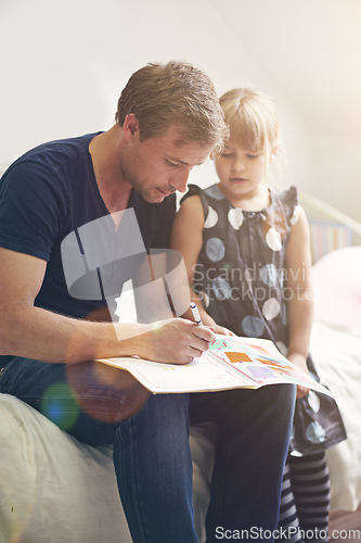 Image of Dedicated to his daughters education. Shot of a single dad helping his daughter with her homework.