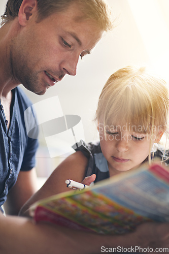 Image of Dedicated to his daughter. Shot of a single dad helping his daughter with her homework.