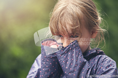 Image of Shes a shy cutie pie. Shot of a shy little girl standing outside.