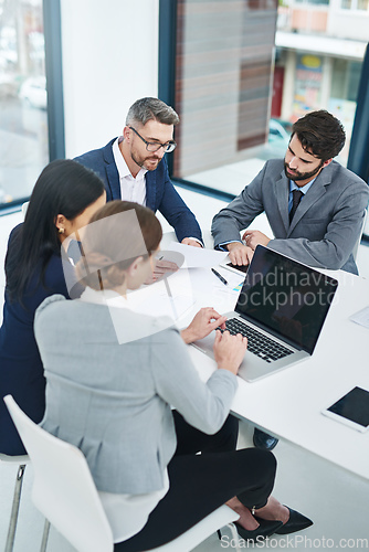 Image of Getting down to business. High angle shot of a group of corporate businesspeople meeting in the boardroom.