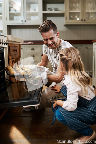 Image of Your muffins came out so perfect. Cropped shot of a young girl and her father baking at home.