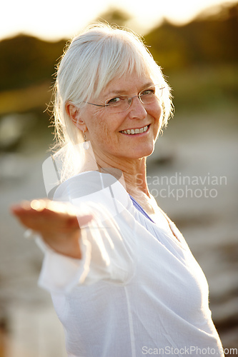 Image of I always feel better after a yoga workout. Cropped portrait of an attractive mature woman doing yoga on the beach at sunset.