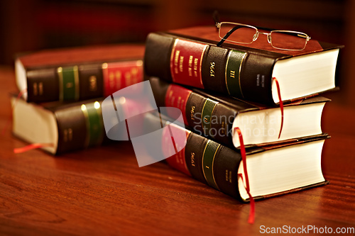 Image of Get to know your rights. Shot of a stack of legal books and a pair of glasses on a table in a study.